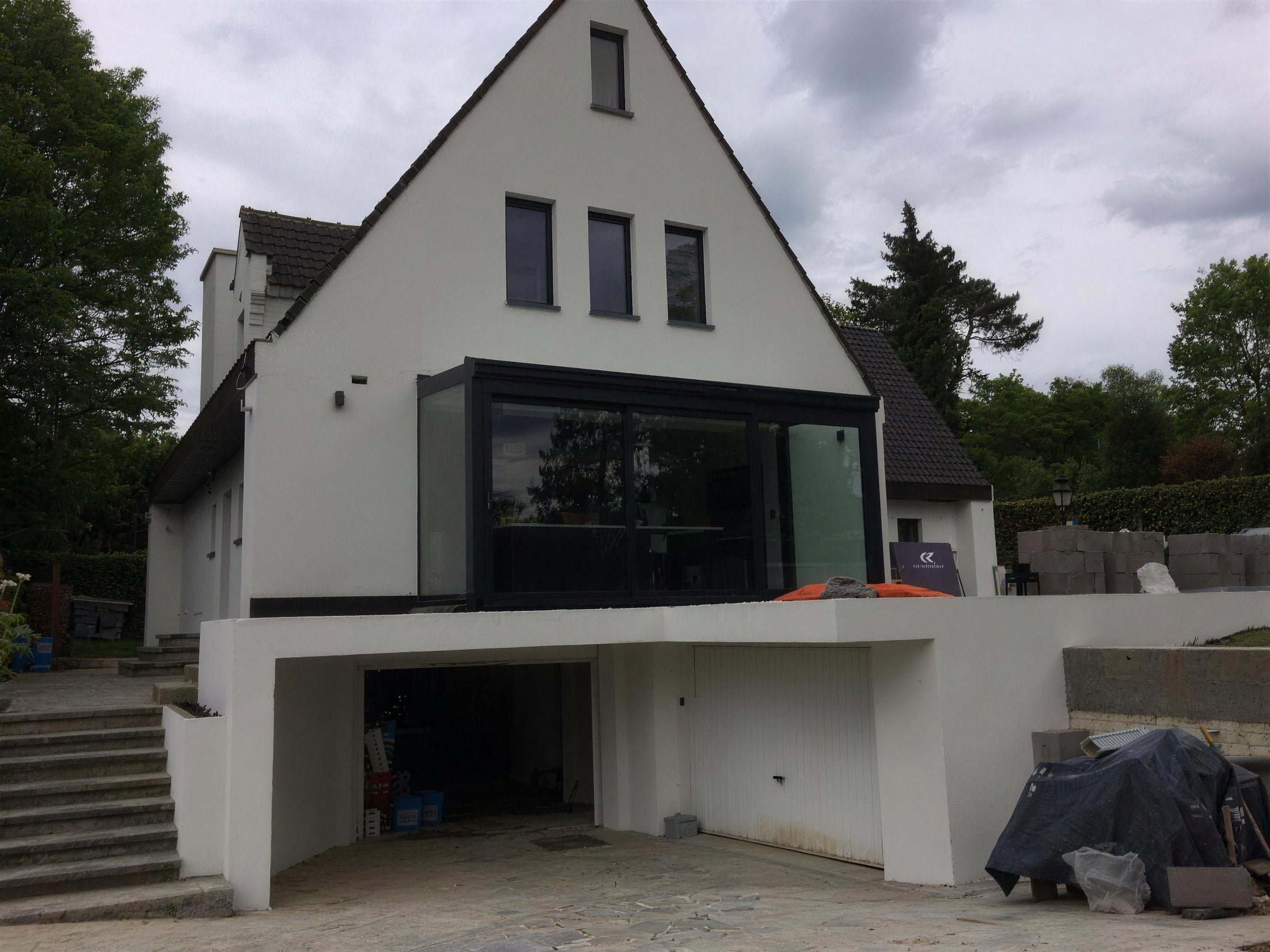 Villa with white render and black window frames, built by Danesy Group